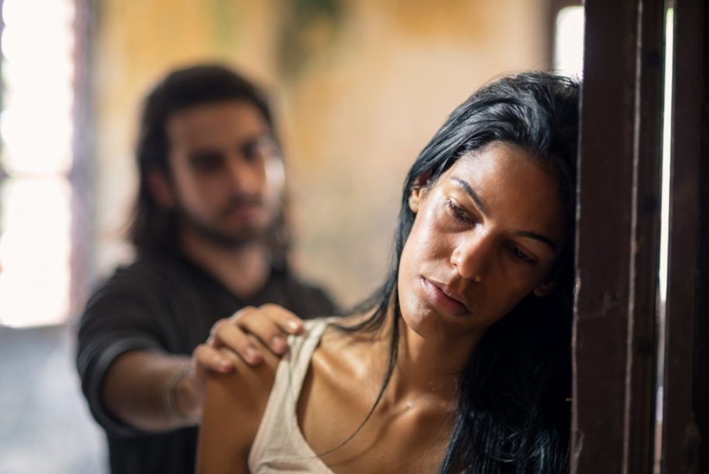 a man tapping the shoulder of a woman