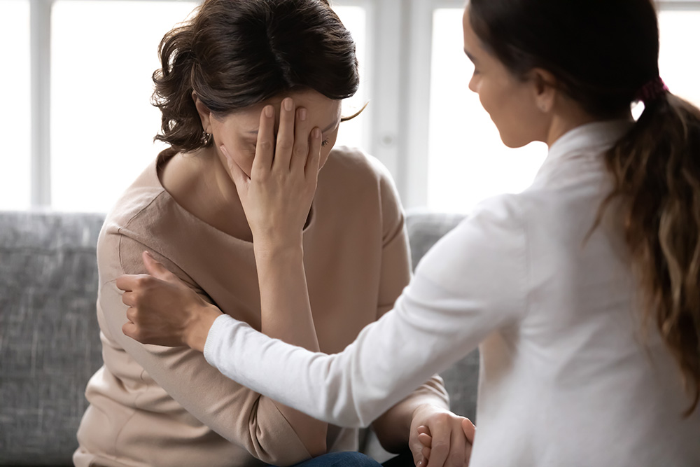 woman receiving comfort for opiat abuse