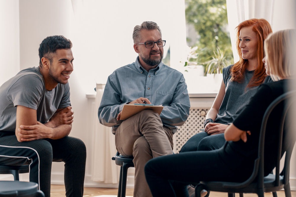 young adults sitting in chairs near each other for therapy