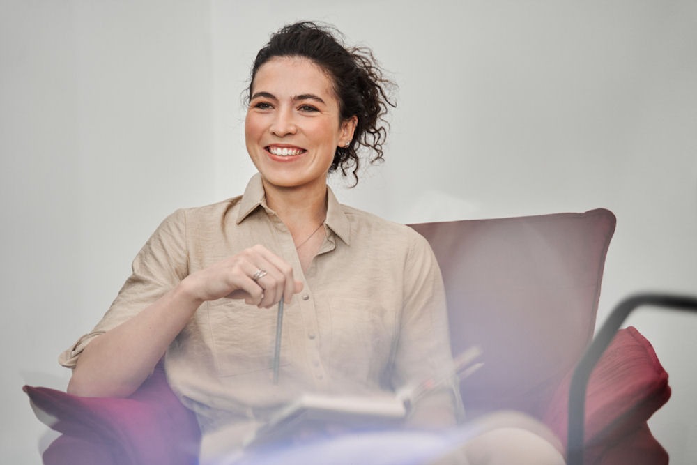 woman sitting in a chair smiling