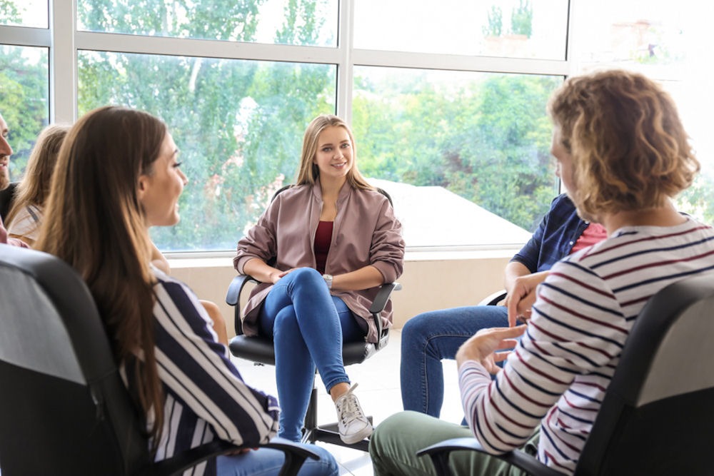 small group of young women and men meeting