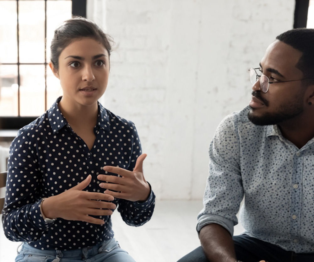 woman discussing mental health issues with group