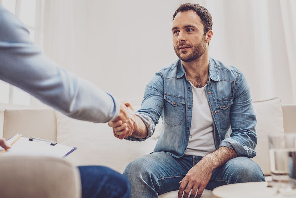 counselor shaking client's hand