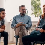 therapist having mental health discussion with small group