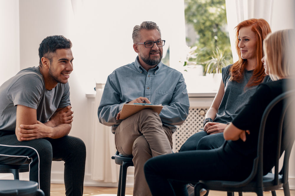 therapist having mental health discussion with small group