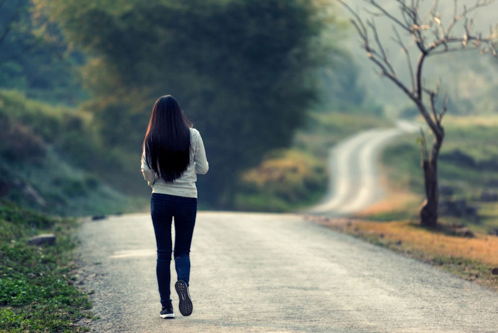 woman walking on a road