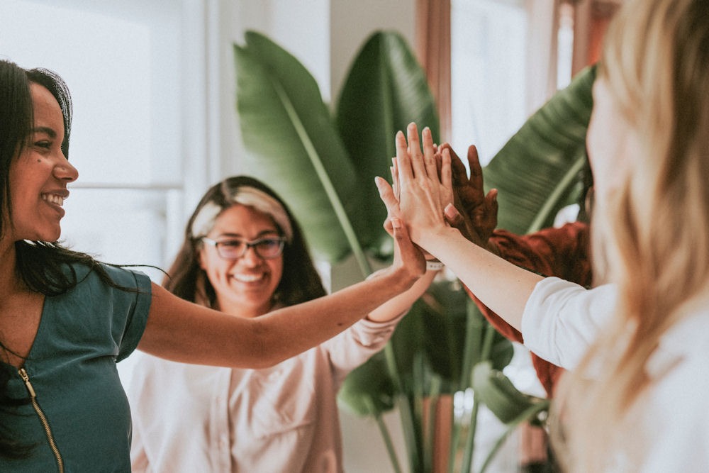 group of women giving high-fives