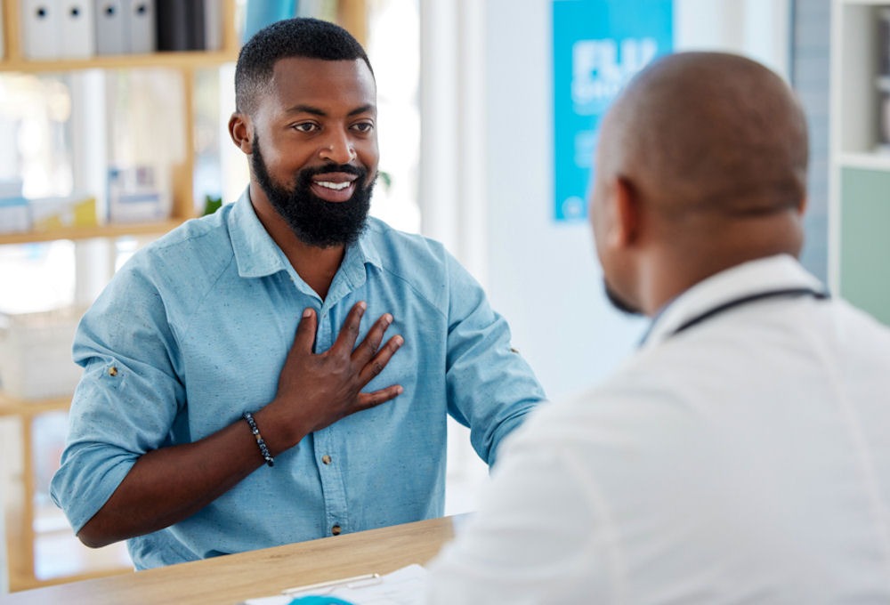 man talking to healthcare professional over a counter