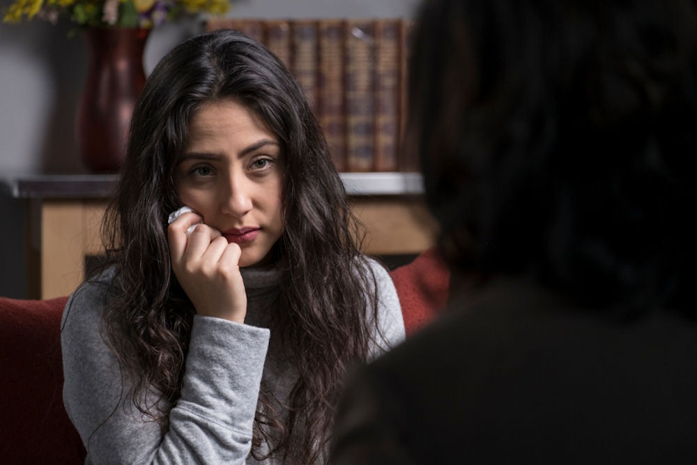 woman listening to counselor in individual therapy session