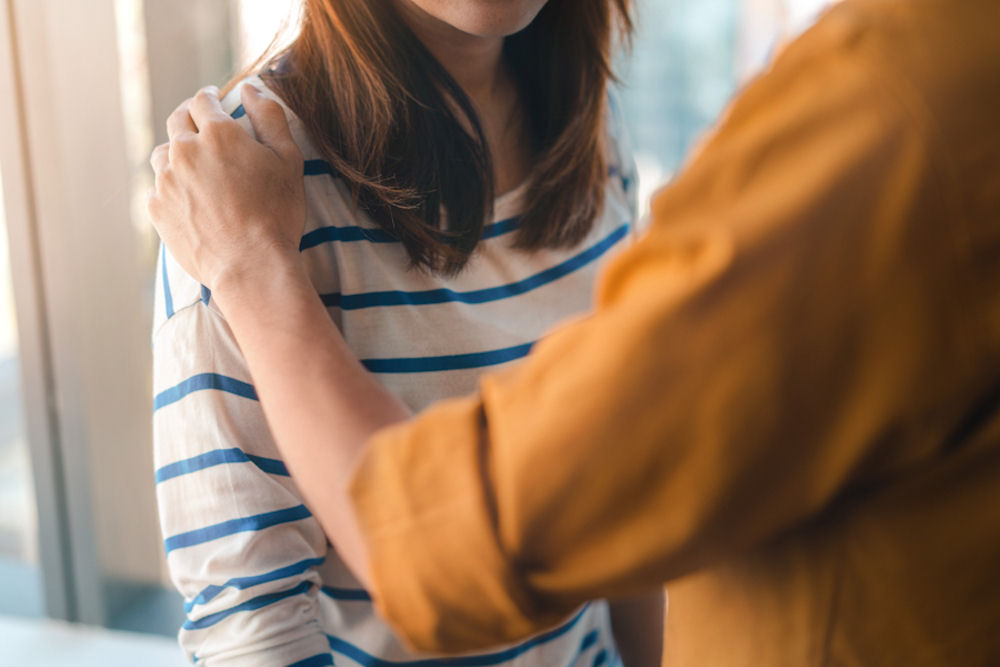 woman comforting another