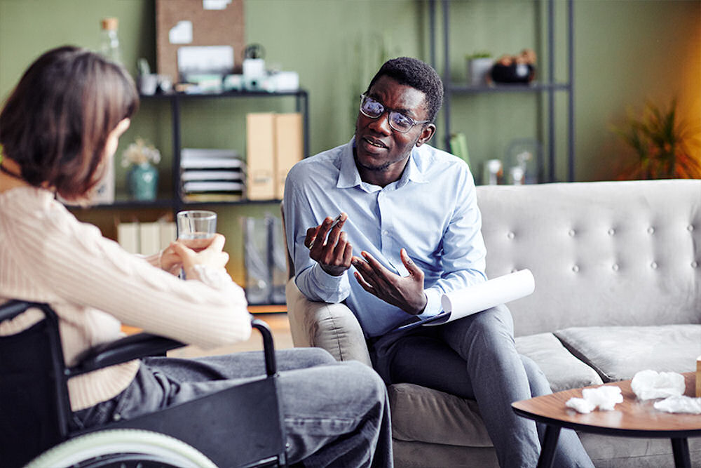 counselor speaking with client in therapy