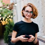 woman with short hair standing outside