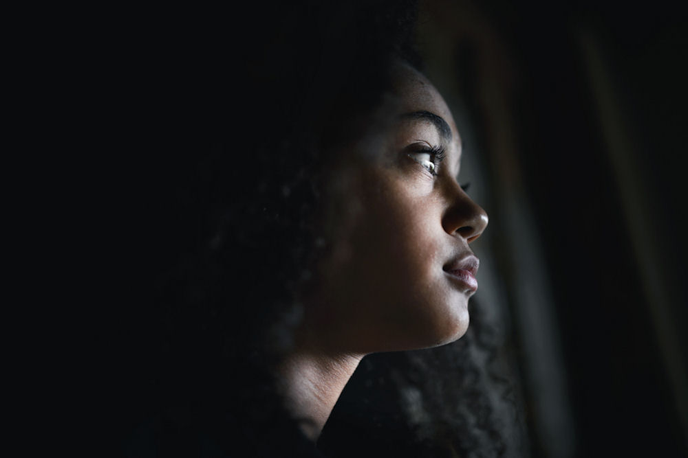 woman looking out window