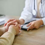 doctor holding patient's hand