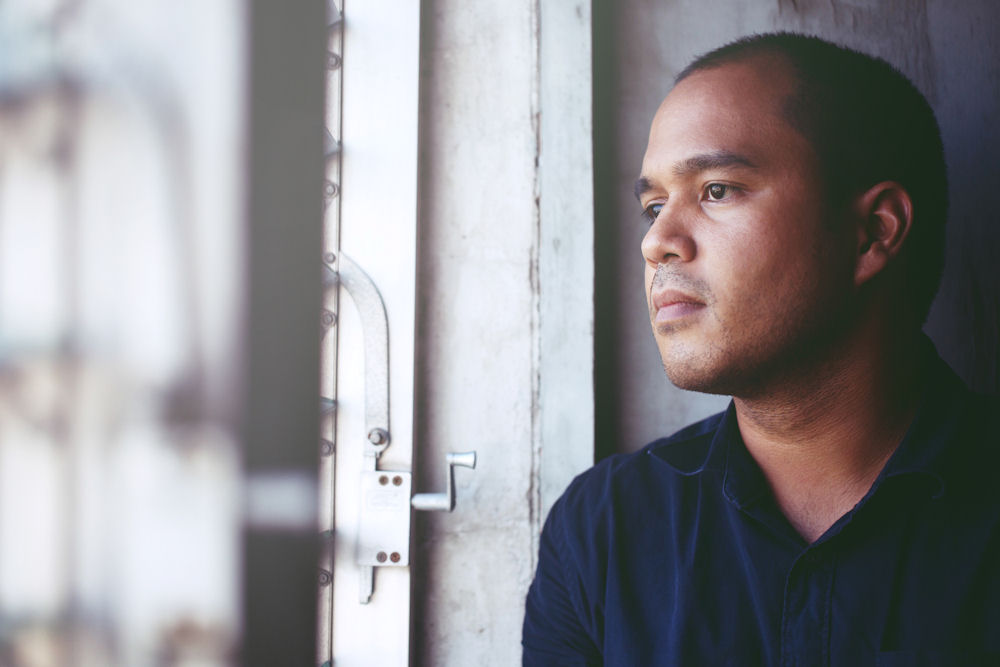 stressed man looking out window