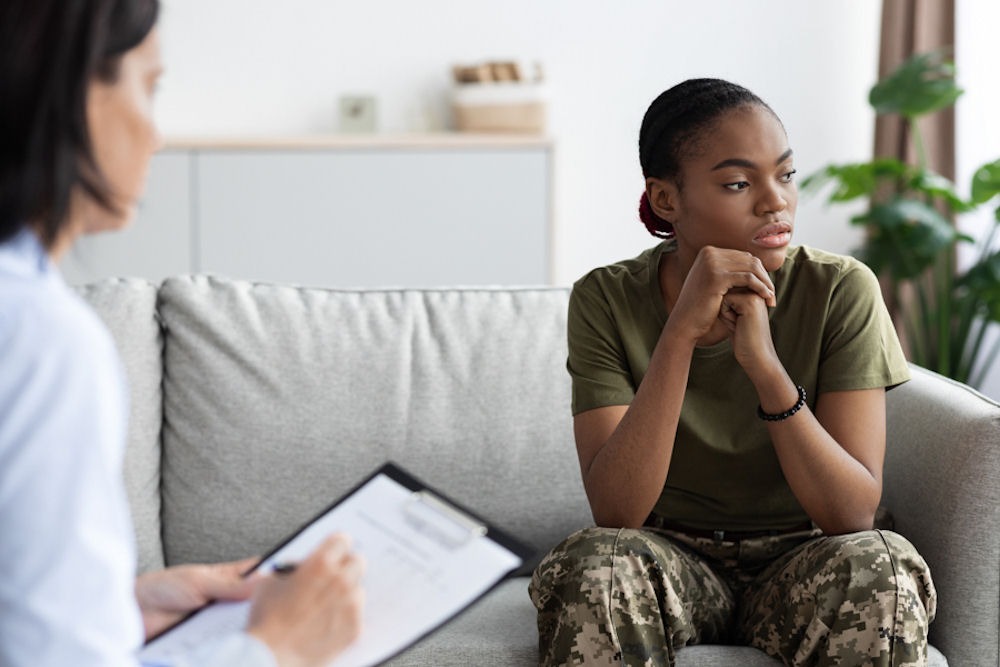 woman in the military sitting on a couch for therapy