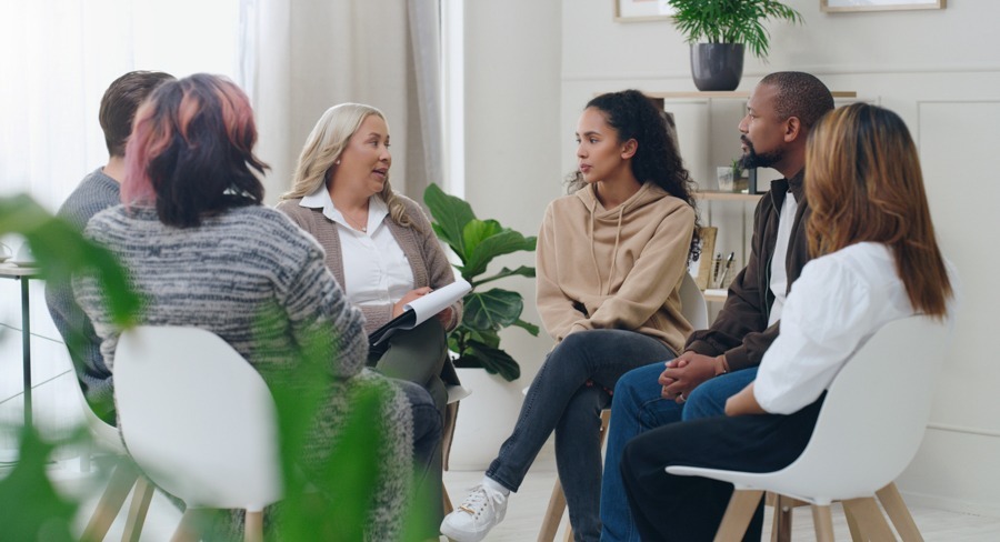 a group of people sitting in a circle