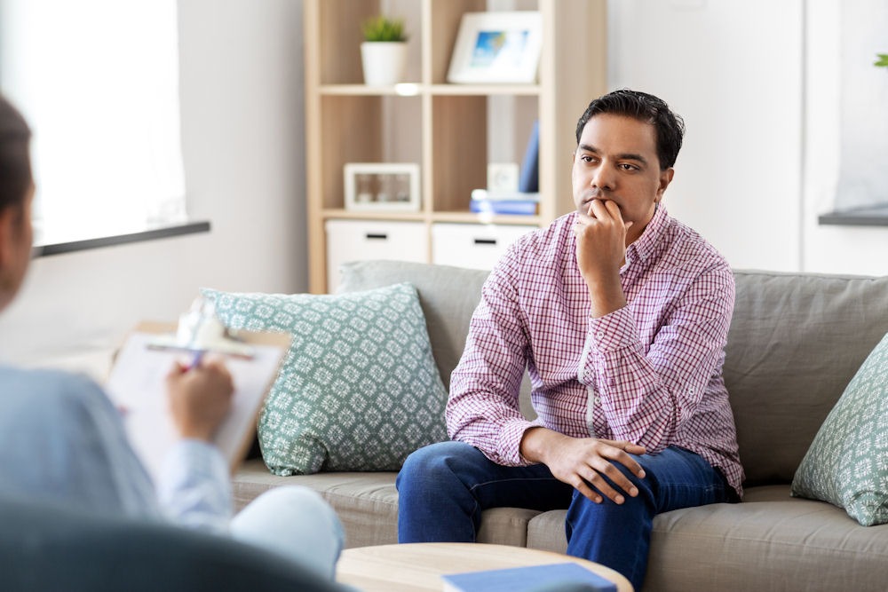 man and psychologist at psychotherapy session