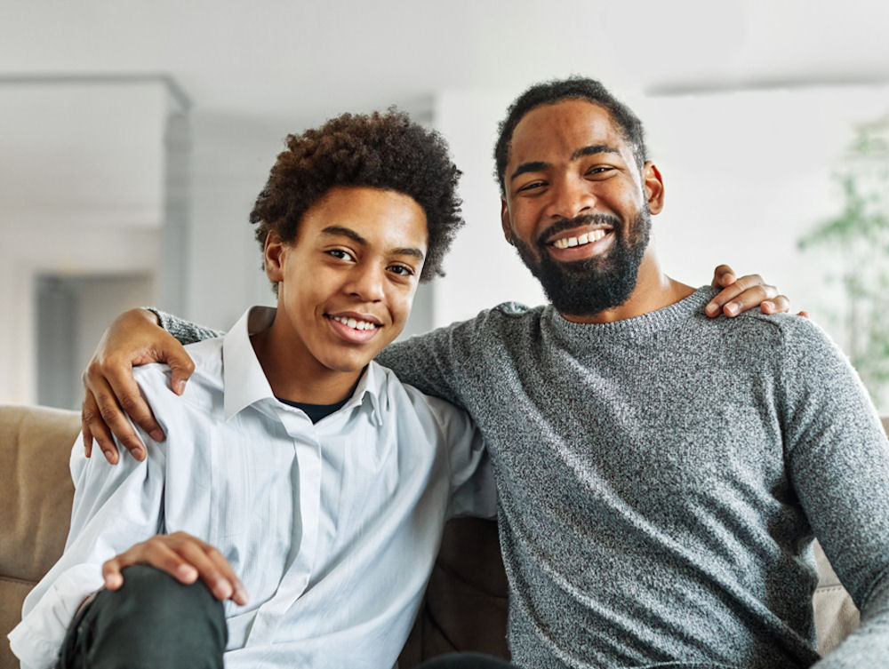 father and son sitting together and smiling