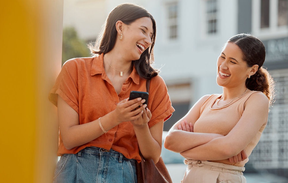 two women outside laughing