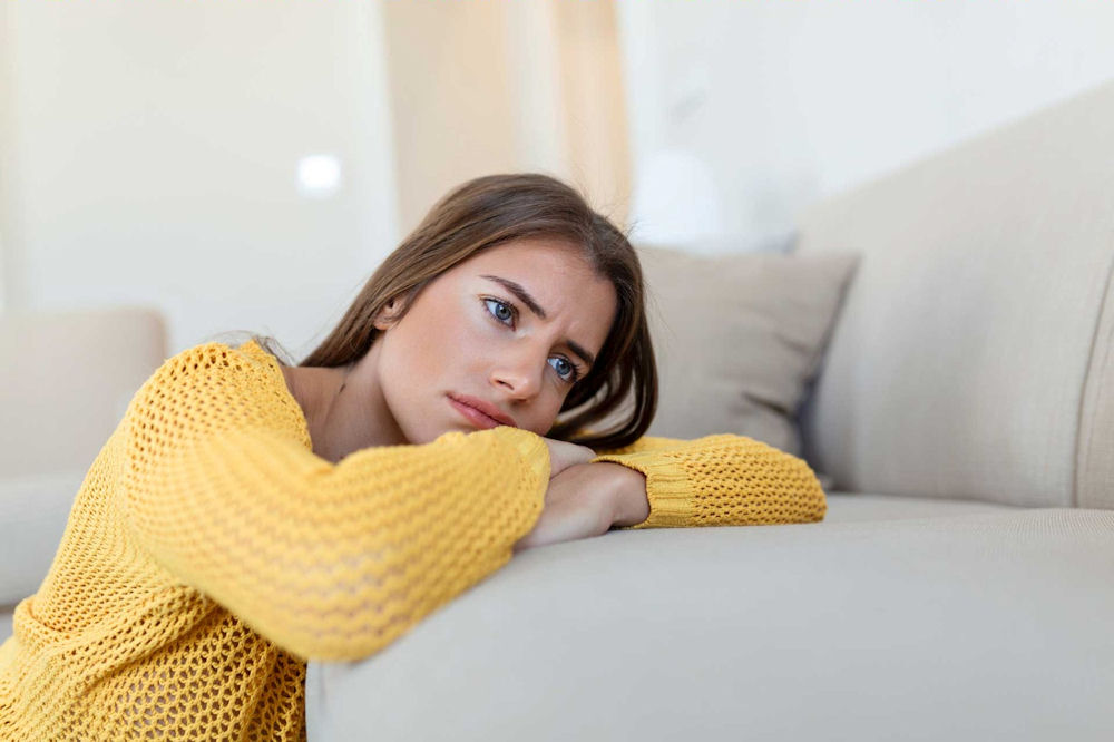 a-woman-laying-on-couch